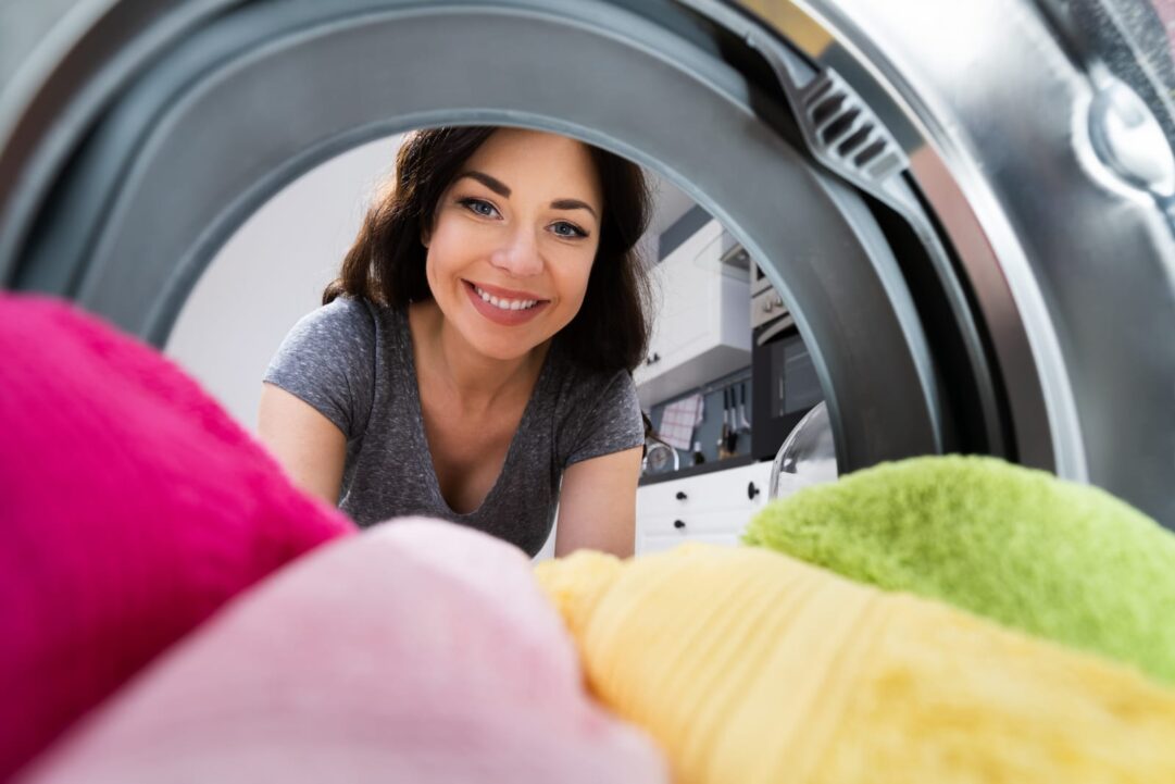 79720970 woman using washing machine appliance